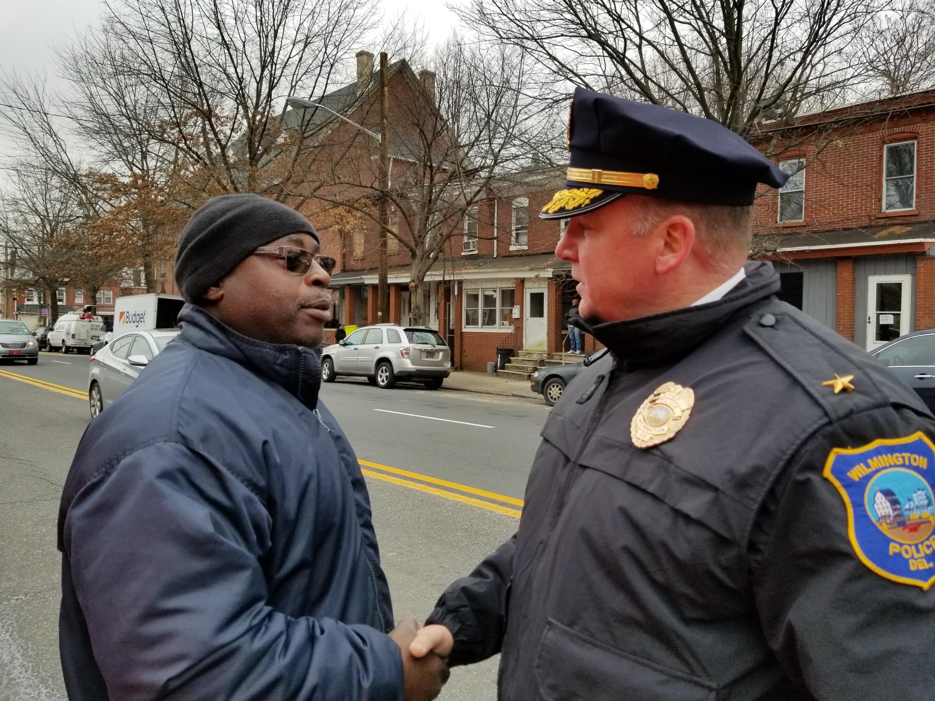 Chief Robert J. Tracy shakes hands with a resident