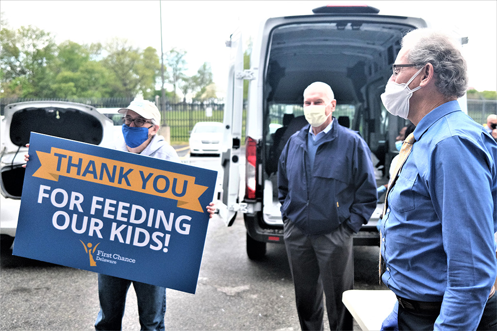 Mayor Mike Purzycki, Delaware First Lady Tracey Quillen Carney, and Parks and Recreation Director Kevin Kelley at the meal preparation site.