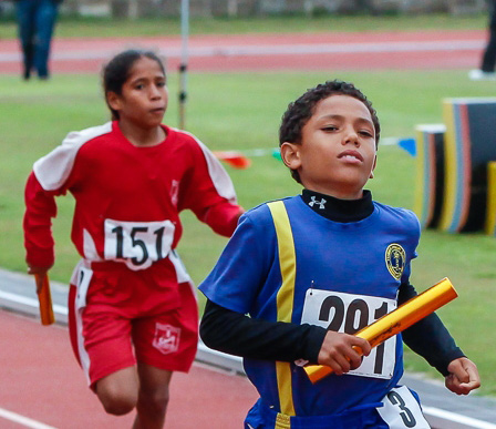 Boy and girl running in a track meet