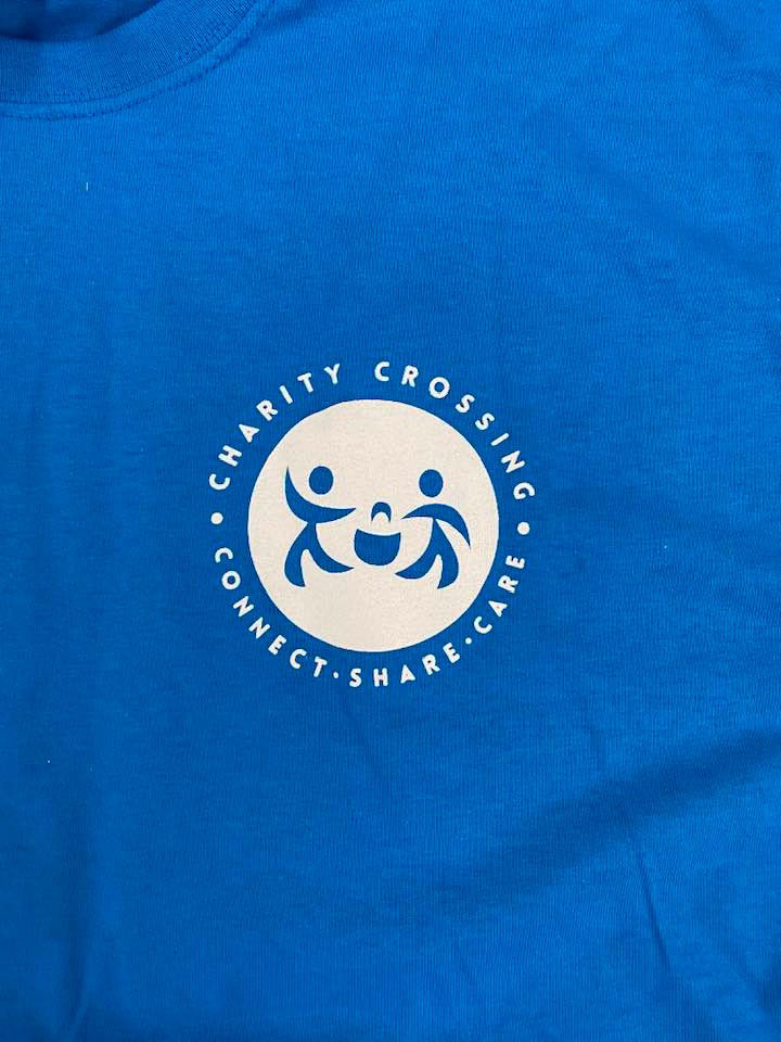 A t-shirt showing the Charity Crossing logo.