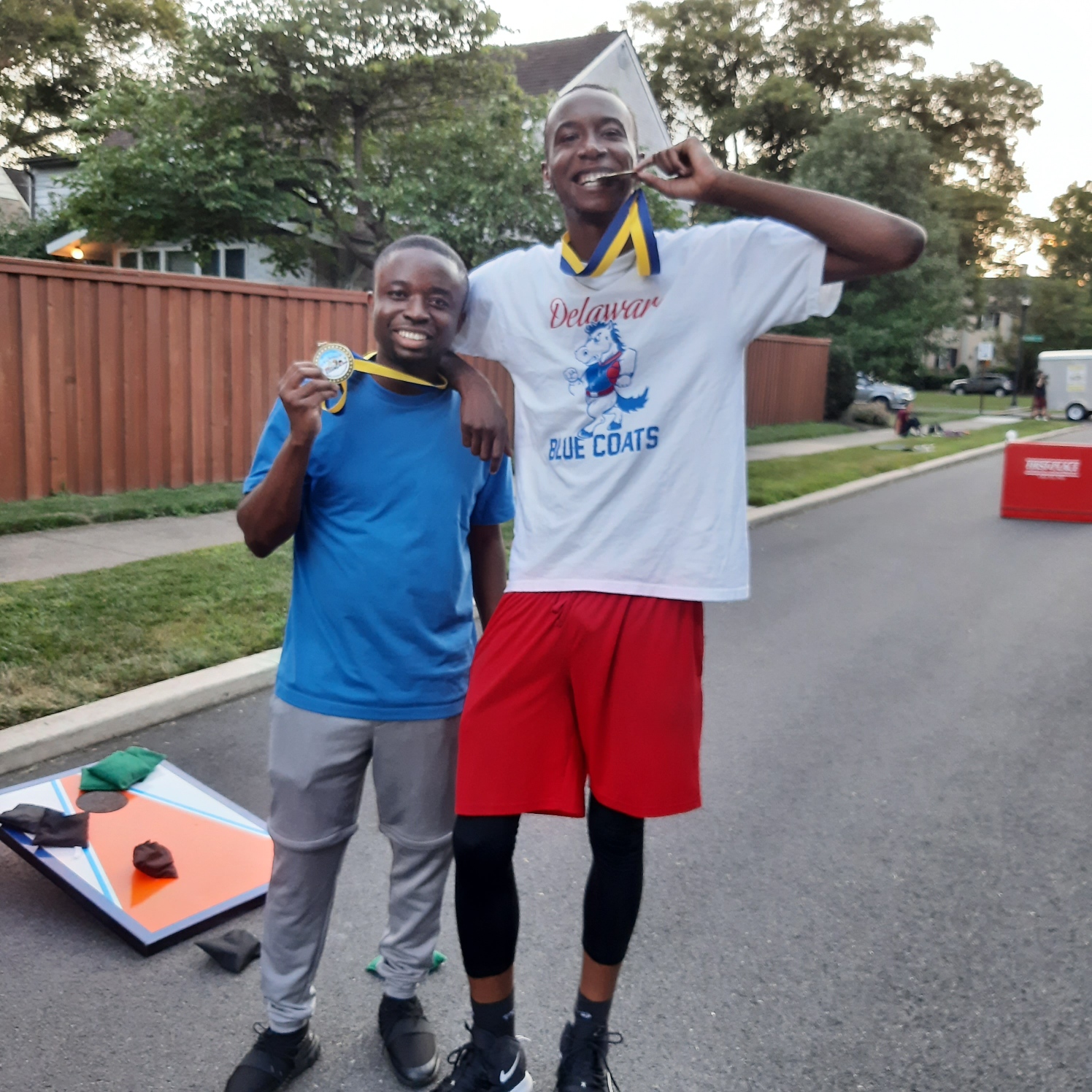 One of the winning cornhole tournament teams with their Play Streets Medals.