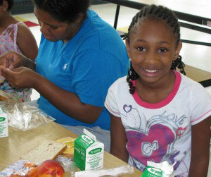 Photo of a child enjoying a healthy lunch