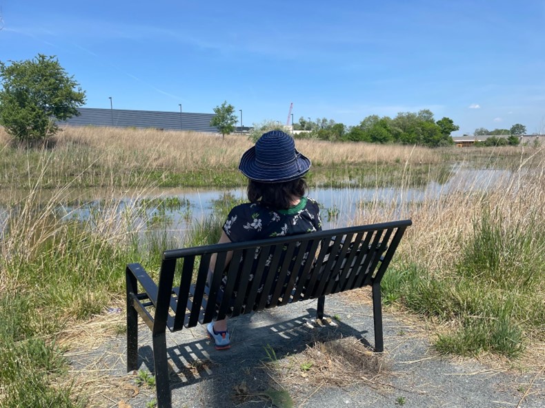 Person sitting on a bench; photo credit J. Harrod